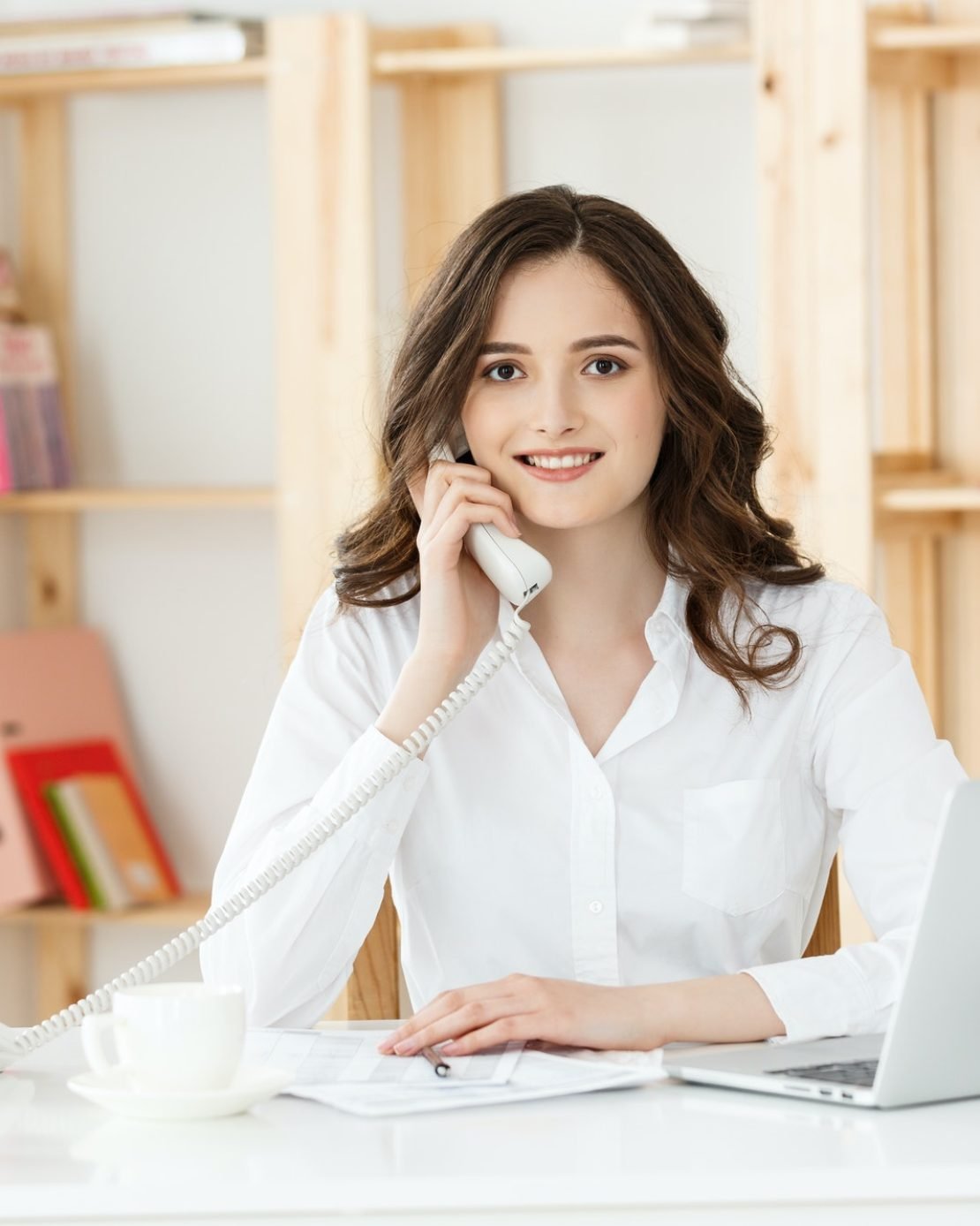 young-woman-talking-on-phone-in-modern-office.jpg